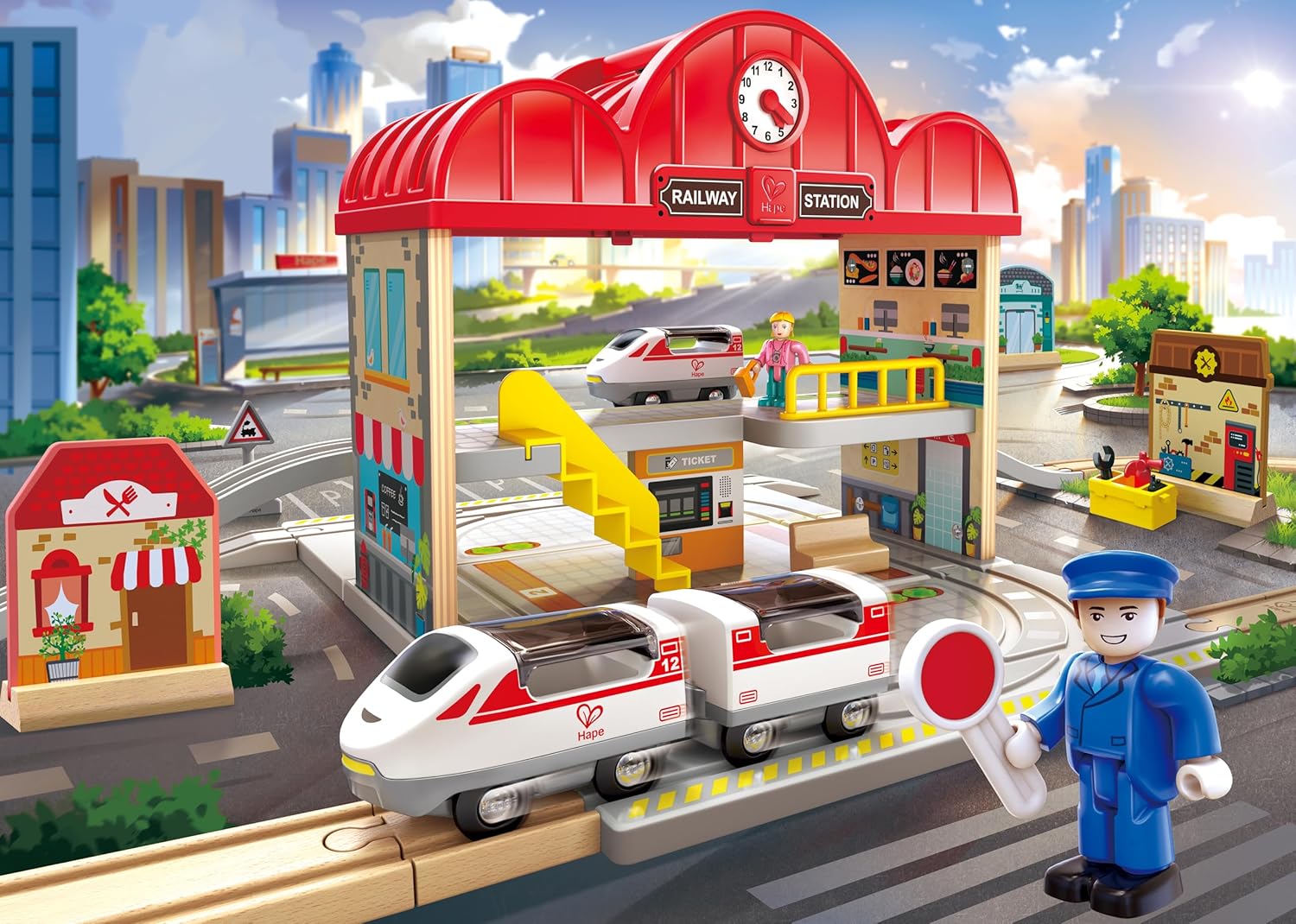 Toy railway station set with train and station staff figure in an urban setting