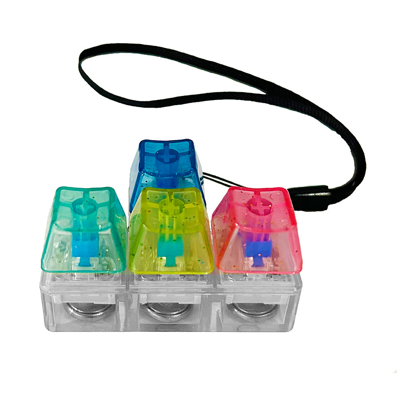 Three transparent keycaps with colored tops on a white background