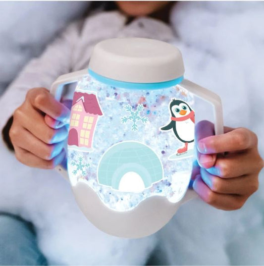 Person holding a mug with a penguin design and snow globe effect